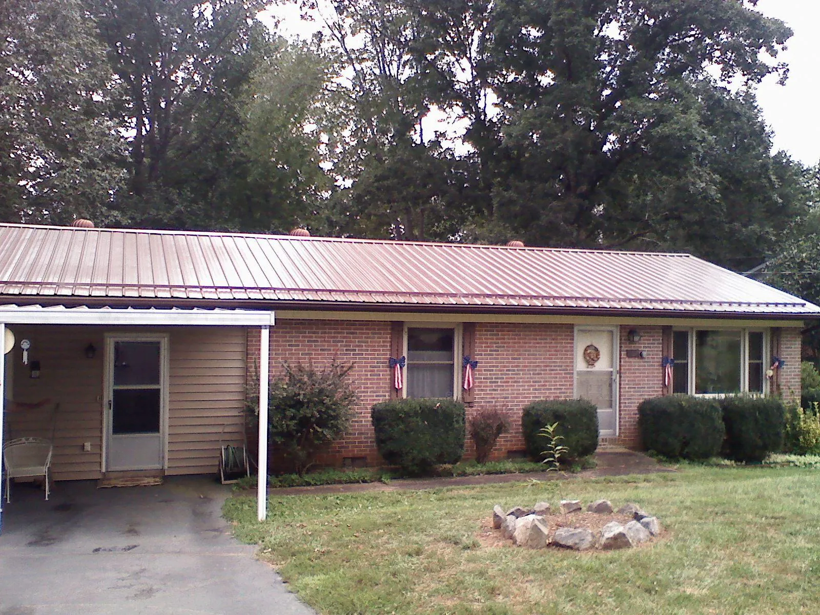 Bronze metal roof and carport on a brick ranch home — Roof Repair work by our crew in Burnsville
